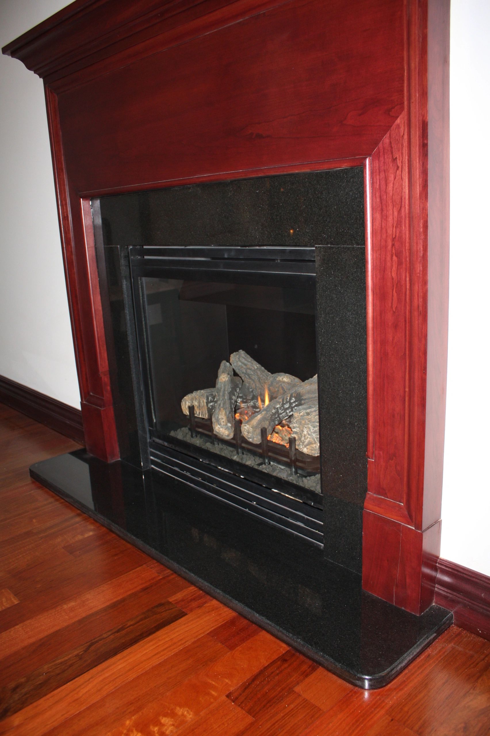 Open red wooden display cabinet with decorative sculpture