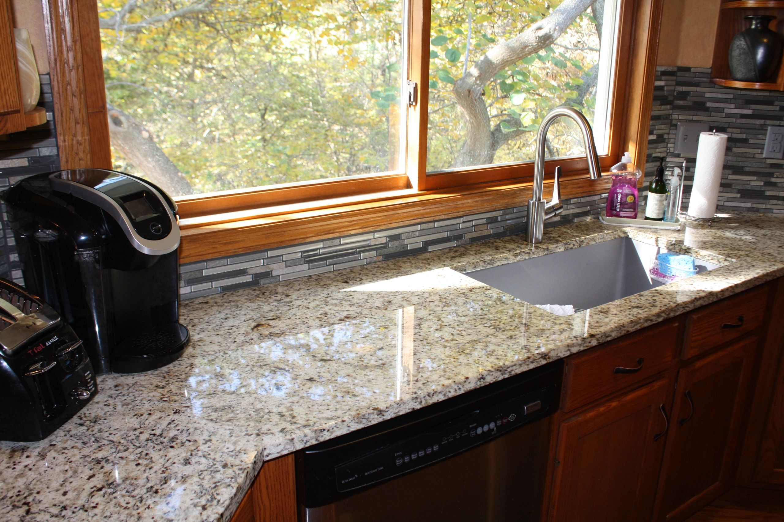 Granite kitchen countertop with undermount sink and wood cabinetry